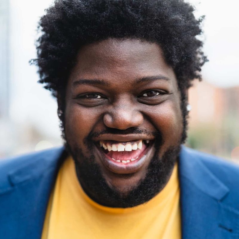 Happy African man smiling front of camera outdoor